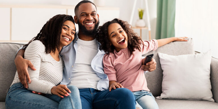 Black Family watching Sitcom on TV